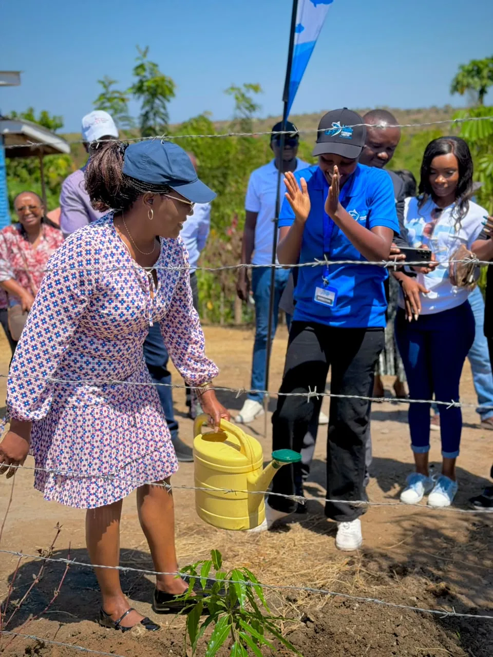 Anne Wang’ombe watering a newly planted tree